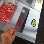 ゴミ箱の投入口にステッカーを貼り付け